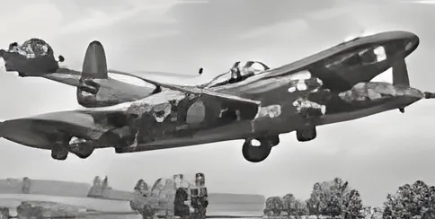 Black-and-white photograph of a Lancaster bomber flying low over an airfield